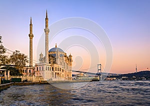 Sunset over Bosphorus and Grand Mecidiye Mosque Ortakoy Mosque, Istanbul, Turkey photo