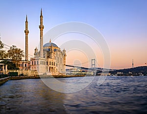 Sunset over Bosphorus and Grand Mecidiye Mosque Ortakoy Mosque, Istanbul, Turkey photo