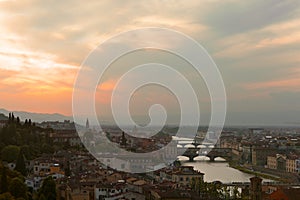 Sunset over bridges through the river Arno