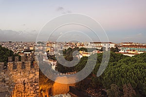 Sunset over buildings in Lisbon, Portugal. Architecture and nature in Europe.