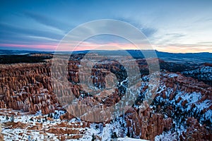 Sunset over canyon slopes covered in snow, Bryce Canyon National