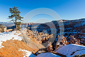 Sunset over canyon slopes covered in snow, Bryce Canyon National