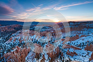 Sunset over canyon slopes covered in snow, Bryce Canyon National