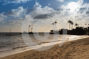 Sunset over catamaran and beach in Kahala, Hawaii