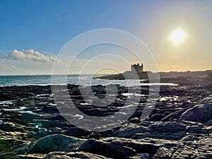 Sunset Over Chateau Turpault at Quiberon Peninsula, Morbihan, with Rocky Shores and Reflective Tidal Pools