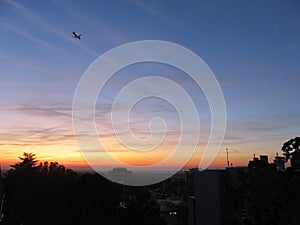 Sunset over the city horizon with plain on sky in autumn