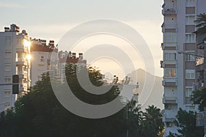 Sunset over the city with mountains in the background (Antalya, Turkey) - Turkish public housing