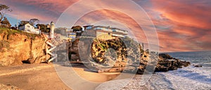 Sunset over the cliffside of One Thousand Steps beach at the ocean`s edge