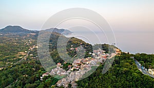 Sunset over coast of Corfu with Pelekas village, Greece