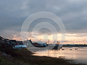 sunset over coast ocean bay water sky sea boats docks