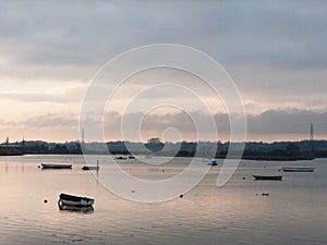 sunset over coast ocean bay water sky sea boats docks