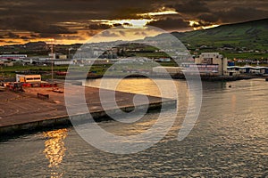 Sunset over the commercial port in Praia de Vittoria from MV Ventura