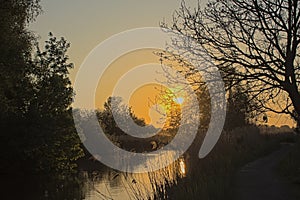 Sunset over a creek in Bourgoyen marshland, Belgium