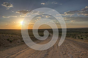 Sunset over dirt road leading to Chaco Culture National Park photo