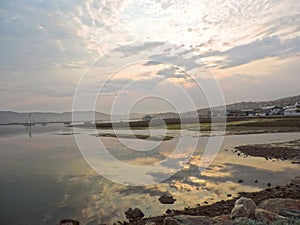 Sunset over estuary reflection in water