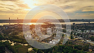 Sunset over European city industrial zone with factories, aerial panorama