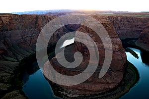 Sunset over famous Horseshoe Bend Utah and Arizona. The beautiful Colorado river carved this horseshoe shaped sandstone reflecting