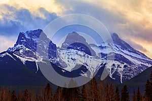 Sunset Over Famous Three Sisters Mountain Peaks in Canmore, Canada photo
