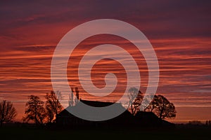 Sunset over farm in nature area Visvliet, Burum near Groningen