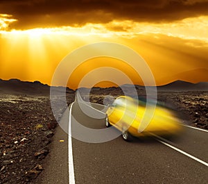 Sunset over fast car and road