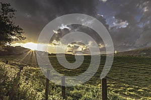 Sunset over field and dramatic sky in Lake District,Cumbria,Uk