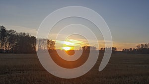 Sunset over a field outside the city