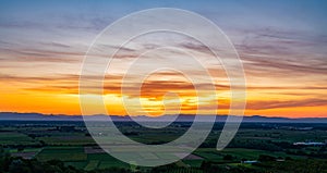 Sunset over fields; Orange sky, cloulds and fields