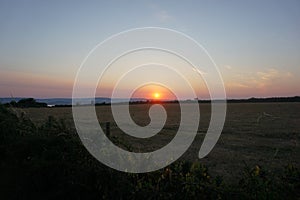 Sunset over fields at Orcombe Point, near Exmouth