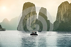 Sunset Over The Fishing Boats And High Rock Mountains At Halong Bay