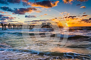 Sunset over the fishing pier and Gulf of Mexico in Naples, Florida. photo