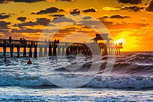 Sunset over the fishing pier and Gulf of Mexico in Naples, Florida. photo