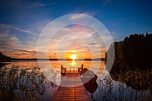 Sunset over the fishing pier at the lake in Finland