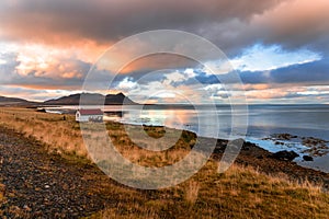 Sunset over a Fishing Shed on a Rocky Coast in Iceland