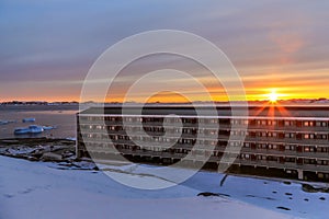 Sunset over the fjord and living blocks in Arctic capital Nuuk c