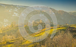 Sunset over the forests and villages from Doftana Valley in Romania at the bottom of Baiului Mountains in autumn landscape after a