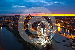 Sunset over the Gdansk city with illuminated ferris wheel, Poland