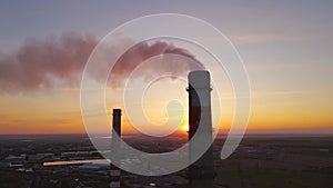 Sunset over the industrial city.Factory chimneys smoke.Environmental problem of environmental