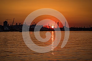 Sunset over industrial port