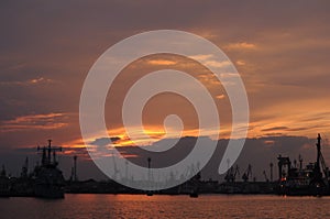 Sunset over an industry harbor with cranes in Bulgaria, Varna