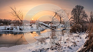 Sunset over the Jeziorka river at winter