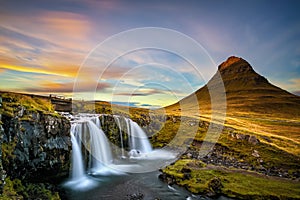 Sunset over Kirkjufellsfoss Waterfall and Kirkjufell mountain in Iceland photo