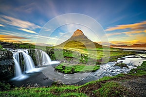 Sunset over Kirkjufellsfoss Waterfall and Kirkjufell mountain in photo