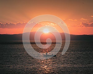 Sunset over Lake Champlain taken from Burlington, Vermont with a small boat center frame