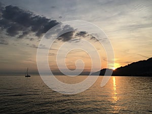 Sunset over Lake Geneva with mountain and boat in view