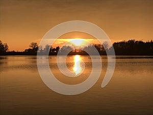 Sunset over a lake near Hradec Kralove in the Czech Republic, Europe.