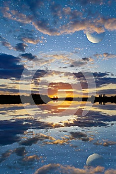 Sunset over the lake on a sky background with planets