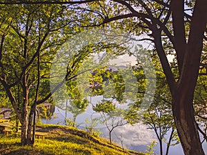 Sunset over the lake in the village, image in the orange-purple toning