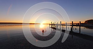 Sunset Over the lake and wooden old pier, 4k video