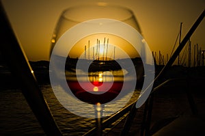 Sunset over marina with fine glass of wine