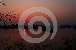 Sunset over the Mekong River near the island of Don Det in the Mekong Delta